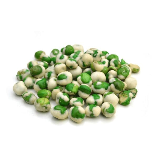 Pile of wasabi peas, green peas coated with white wasabi shell, on white surface.