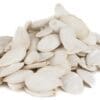Pile of white pumpkin seeds on white background, smooth, flat, and oval in shape.