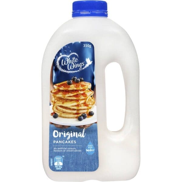 Plastic container with blue cap labeled "White Wings Original Pancakes," showing pancakes and blueberries.