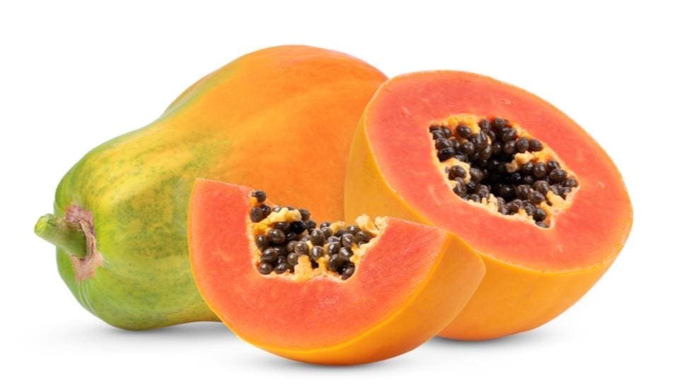 A whole papaya and two halves with orange flesh and black seeds are shown.