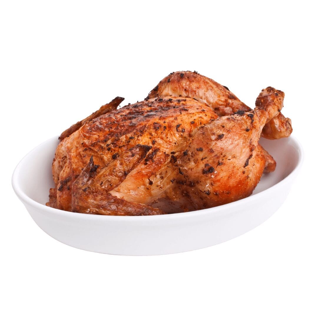 Whole roasted chicken on a white dish, browned and seasoned.